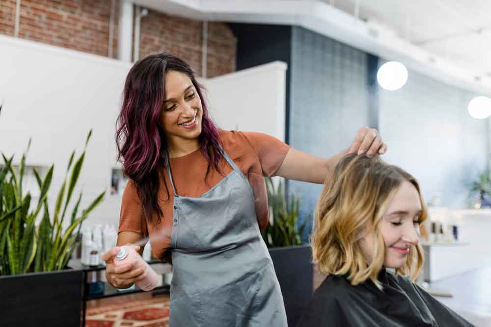 Hairdresser doing a clients hair